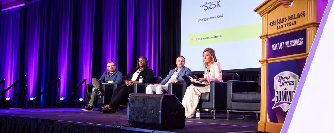 Dealership professionals answering questions on stage at a conference